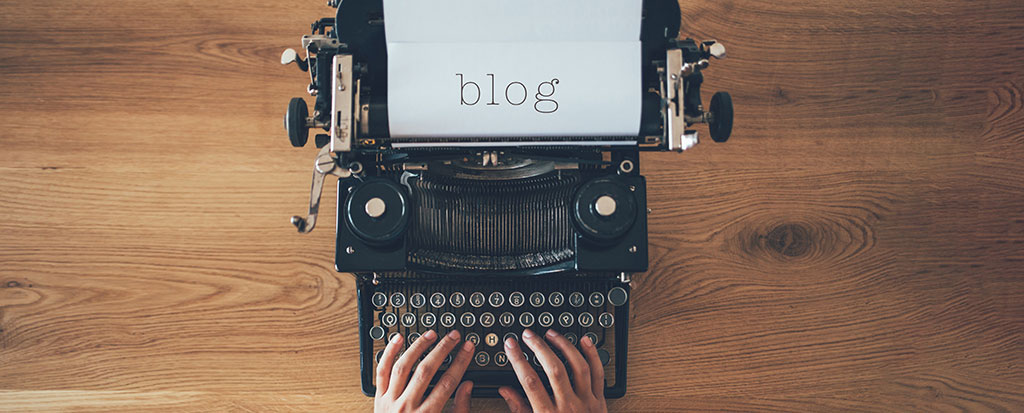an image of someone typing on a type writer with the word "blog" on the paper to represent the Parasec blog.