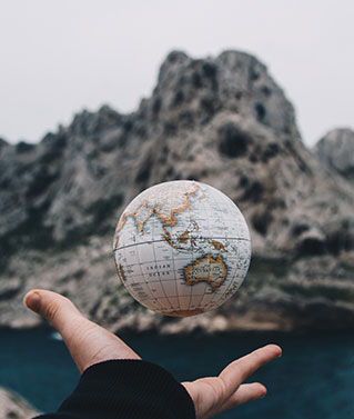 an image of a human hand tossing up a small globe to represent our apostille & legalization services.