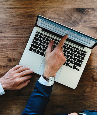 a man looking at a business license application online.