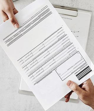 an image of two people passing a UCC document to each other to represent our UCC services.