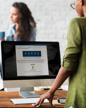 Woman looking at computer and starting to file her beneficial ownership information (BOI) reports.