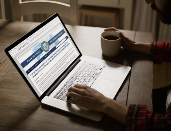 Image of someone on a laptop reading a press release from FinCEN about how it has eliminated the BOI Reporting for US Companies